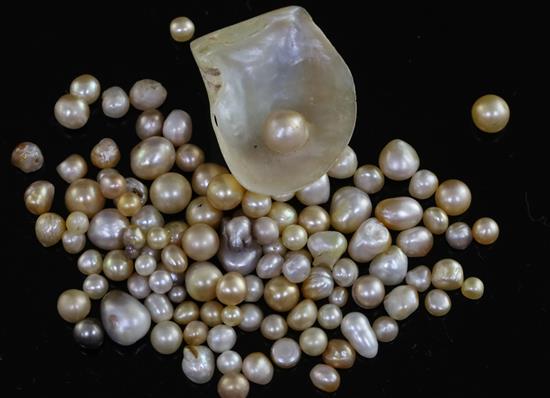 A quantity of loose undrilled (untested) pearls, of varying shapes, colours and sizes including a pearl in half shell,